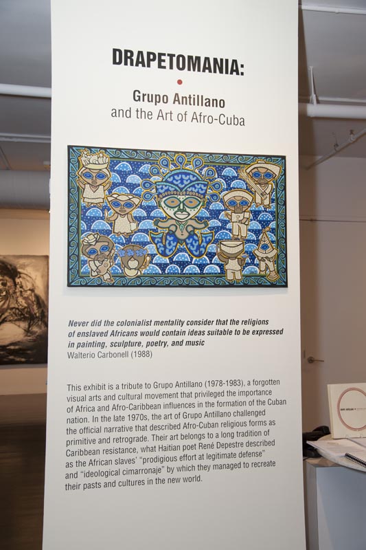 Front text of the exhibit, with painting by Leonel Morales